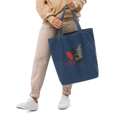 alpha gamma delta 1904 blue denim tote bag in model's hands