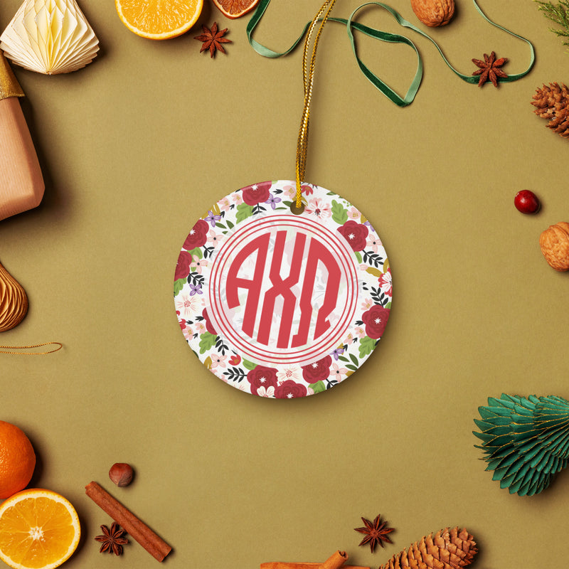 Alpha Chi Omega Ceramic Holiday Ornament shown on white background with gold hanging string with holiday accents