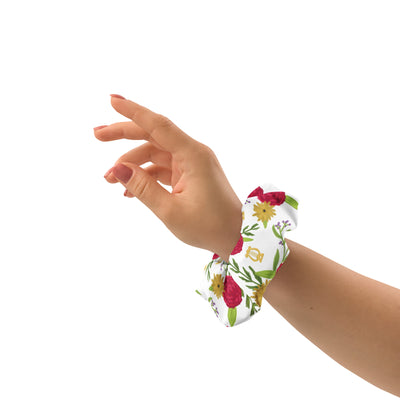 Alpha Chi Omega Carnation Floral Print Scrunchie in white on woman's wrist