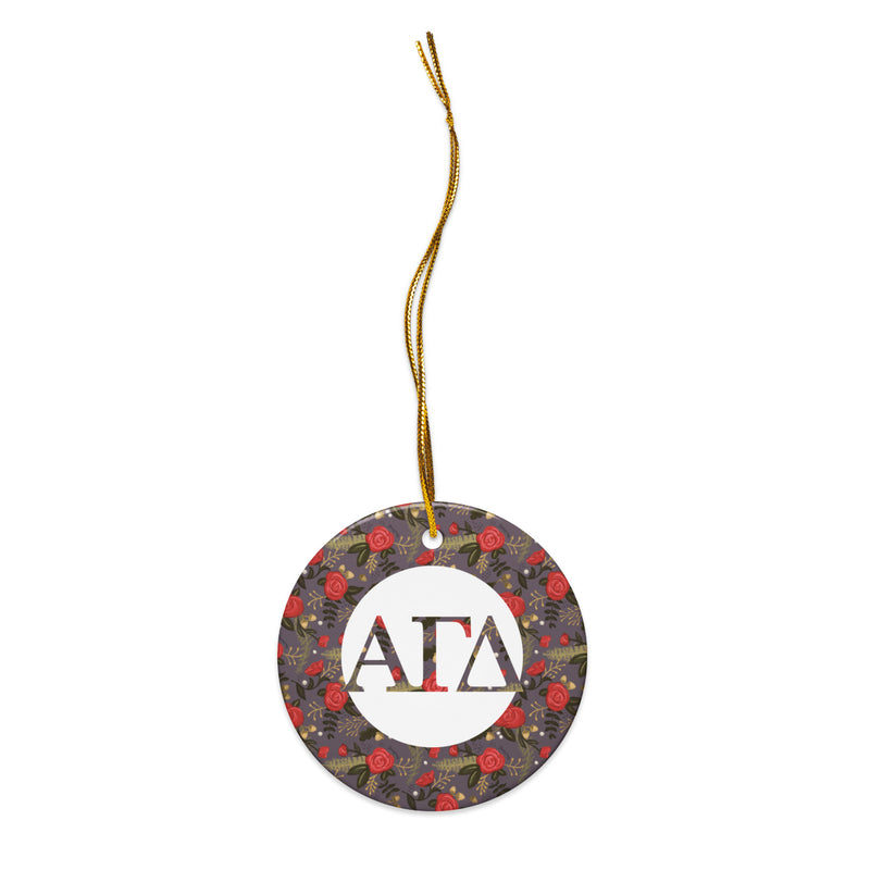 Alpha Gamma Delta Holiday Ornament shown with gold hanging thread featuring filled letters and red rose floral print