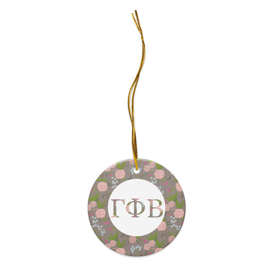 Gamma Phi Beta Ceramic Holiday Ornament shown with gold hanging thread with our filled letters and floral print trim in a la mode