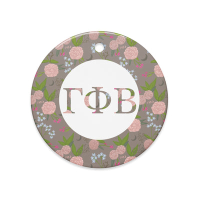 Gamma Phi Beta Ceramic Holiday Ornament shown in full view with our filled letters and floral print trim in a la mode