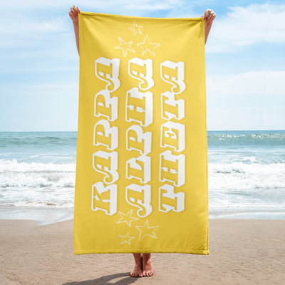 Kappa Alpha Theta Beach Towel held up by model at beach