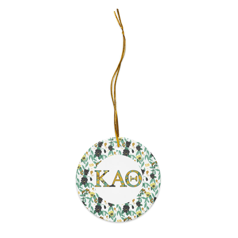 Kappa Alpha Theta Holiday Ornament shown with gold hanging thread and filled Theta letters and floral print trim
