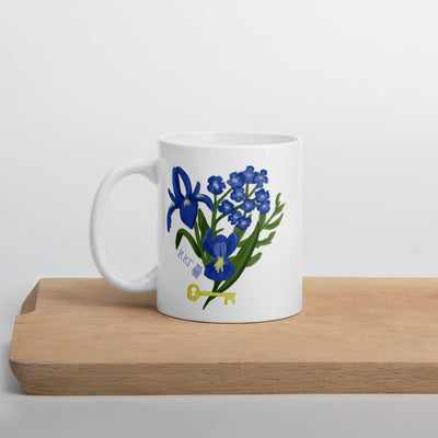 Kappa Kappa Gamma Fleur de Key Mug in white shown on a wooden shelf in 11 oz size