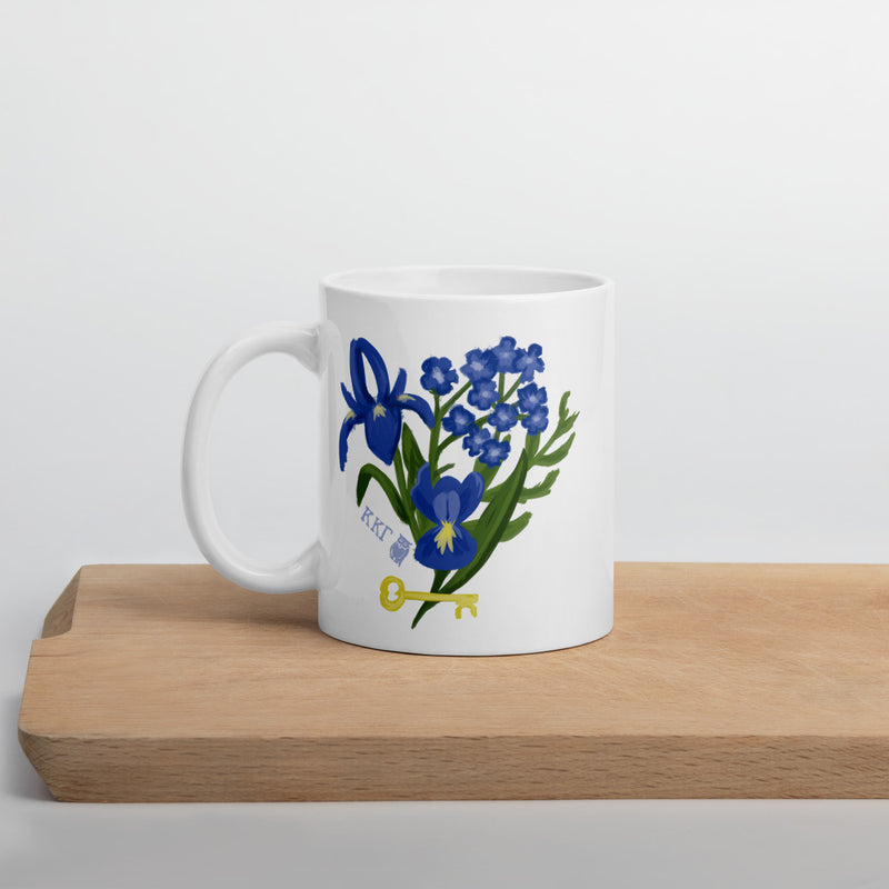 Kappa Kappa Gamma Fleur de Key Mug in white shown on a wooden shelf in 11 oz size