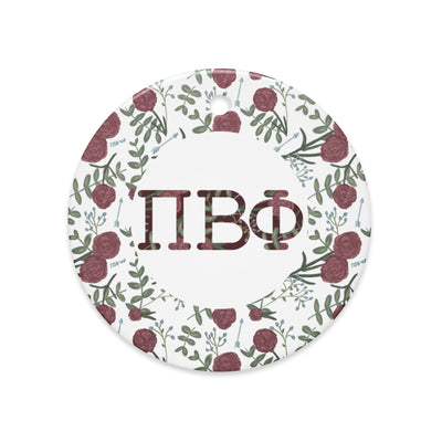 Pi Beta Phi holiday ornament shown in full view with filled letters and carnation floral print