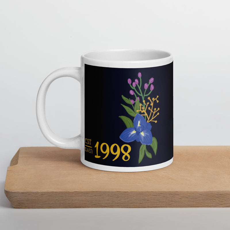 Sigma Alpha Epsilon Pi founding year mug in dark blue with hand-drawn design shown on wooden board