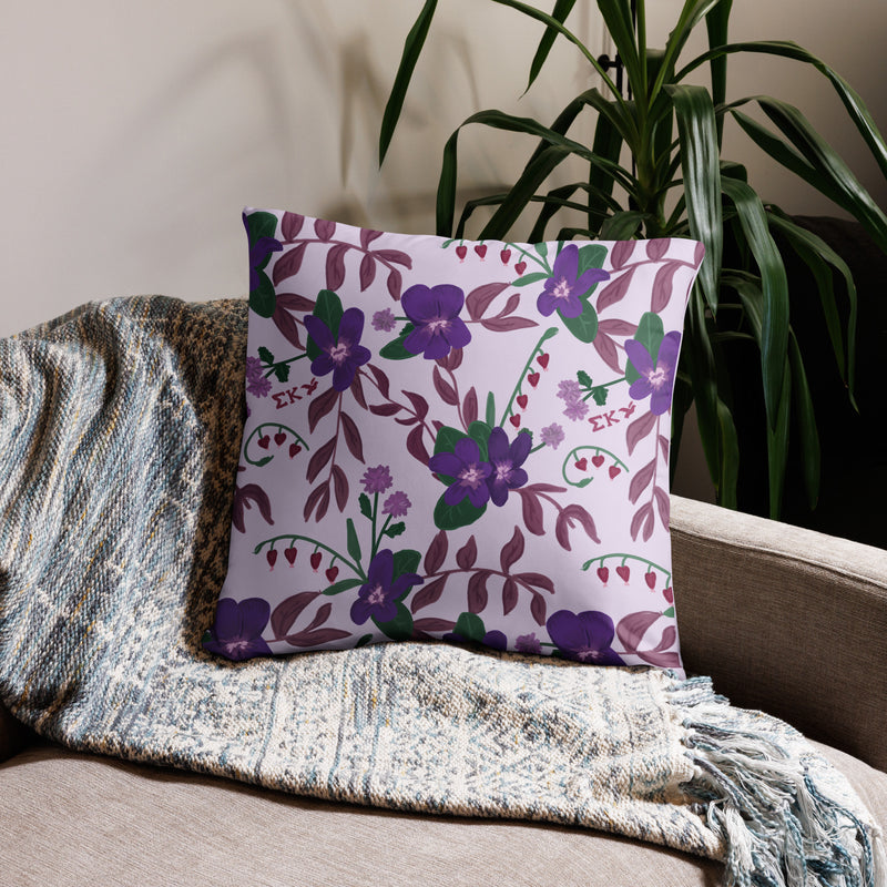 Sigma Kappa Dove Mascot Reversible Pillow showing floral print on back of 22" x 22" size pillow shown on couch