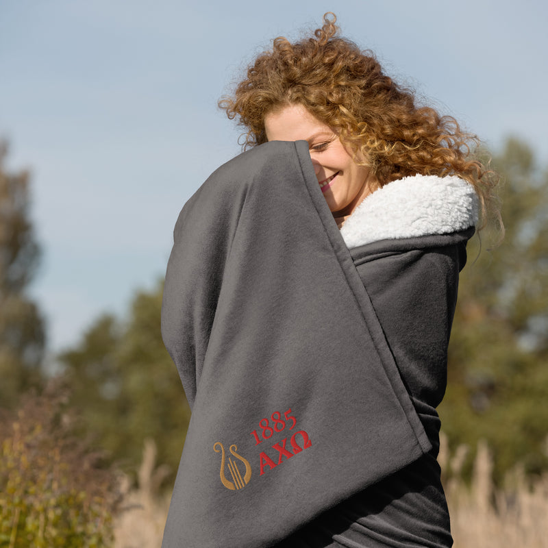 Alpha Chi Omega Plush Embroidered Sherpa Blanket in gray on model