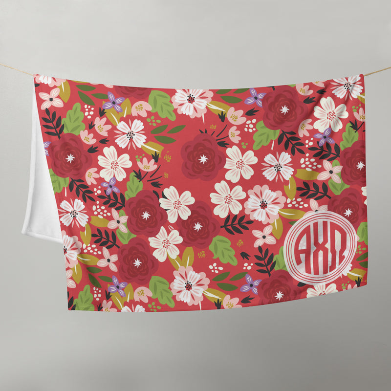 Alpha Chi Omega Modern Floral Blanket in Scarlet red on clothesline