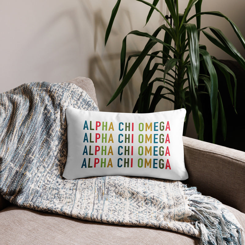 Alpha Chi Omega Colorful Repeat Pillow in lumbar pillow size 20" x 12" on couch