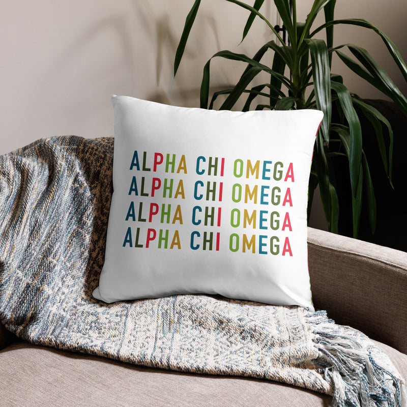 Alpha Chi Omega Colorful Repeat Pillow in 22" x 22" size shown on couch