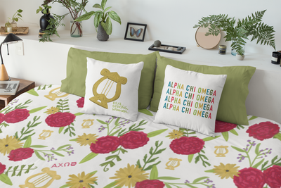 Alpha Chi Omega Duvet Cover showing red carnation and lyre floral print on bed with pillows