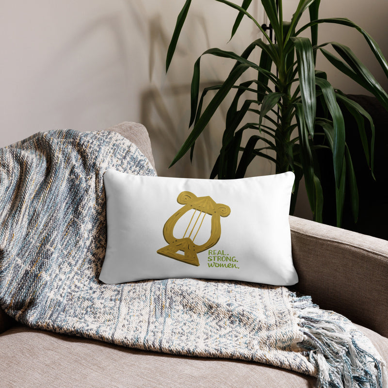 Alpha Chi Real.Strong.Women Pillow in white shown on couch in 20" x 12" lumbar pillow size