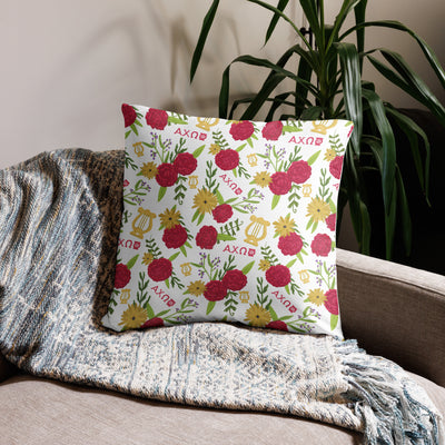 Alpha Chi Real.Strong.Women Pillow in white shown on couch in 22" x 22" size with carnation floral print on back