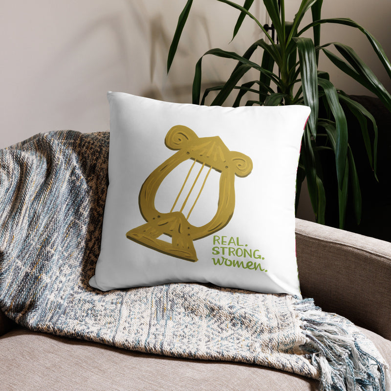 Alpha Chi Real.Strong.Women Pillow in white shown on couch in 22" x 22" lumbar pillow size