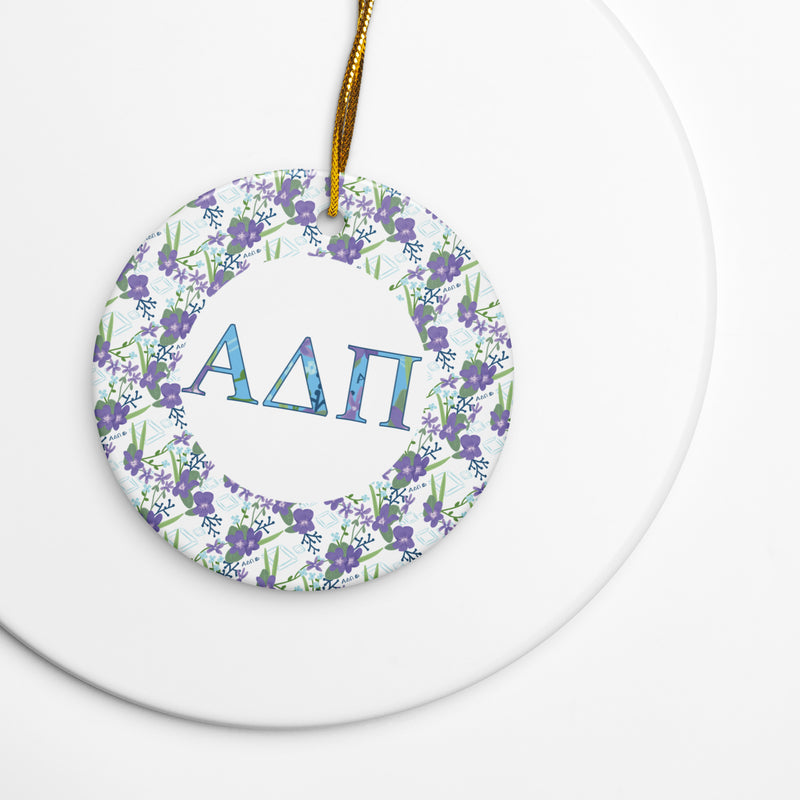 Alpha Delta Pi Holiday Ornament shown with gold hanging cord featuring filled ADPi letters and floral accent
