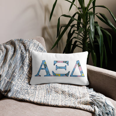 Alpha Xi Delta Sorority Letters Pillow in white in 20 x 12 size shown on couch