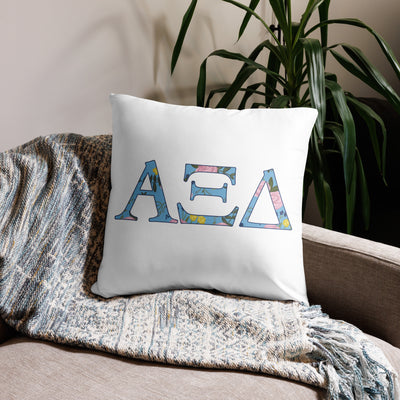 Alpha Xi Delta Sorority Letters Pillow in white in 22 x 22 size shown on couch