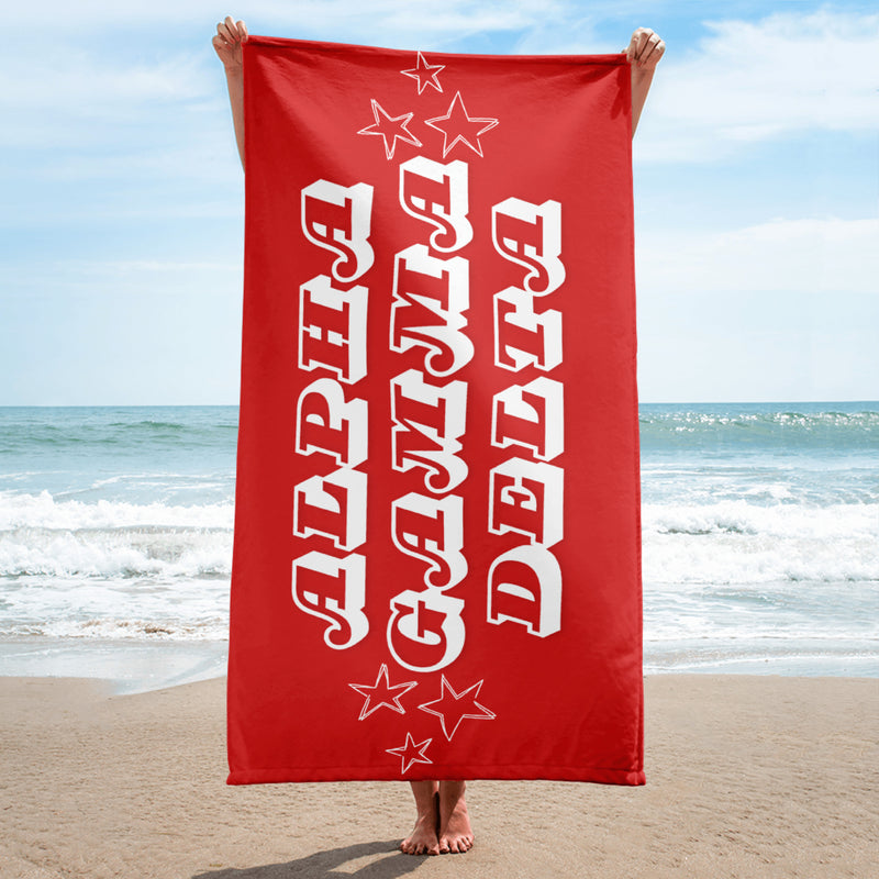 alpha gam beach or bath sorority towel held up in beach scene by model