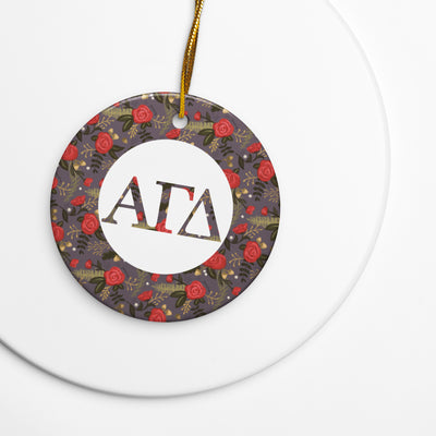Alpha Gamma Delta holiday ornament shown on white background with filled letters and red rose floral print