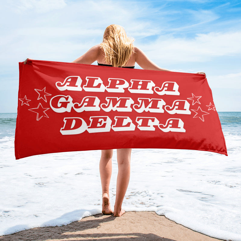 Alpha Gamma Delta sorority towel in red with stars in beach scene