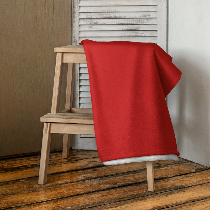 Alpha Gamma Delta Squirrel Towel shown folded over wood stool in lifestyle setting