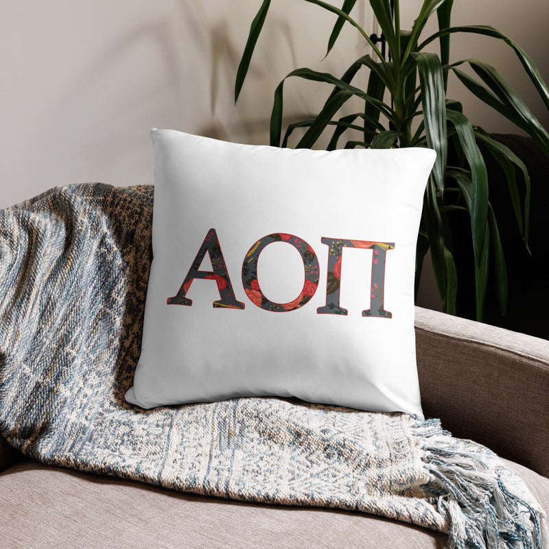 Alpha Omicron Pi Letters Pillow in white on front of 22 x 22 size pillow size shown on couch