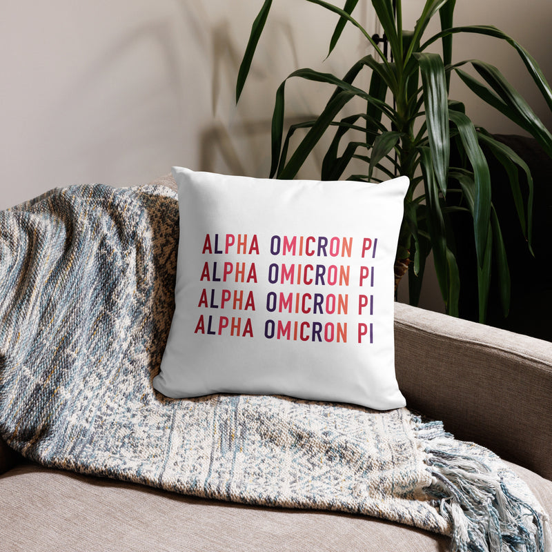 Alpha Omicron Pi Letters Pillow in white showing repeat pattern on back of 18 x 18 size shown on couch