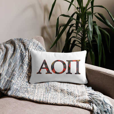 Alpha Omicron Pi Letters Pillow in white on front of 20 x 12 size lumbar pillow size shown on couch