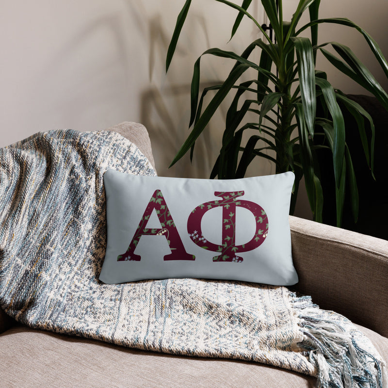 Alpha Phi Letters Sorority Pillow in 20" x 12" rectangular size shown on chair