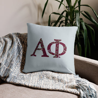 Alpha Phi Letters Sorority Pillow in 22" x 22" square size shown on chair