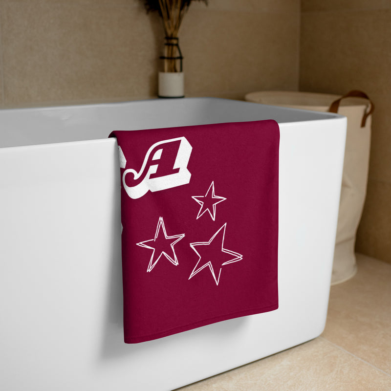 Alpha Phi Starry Beach Towel draped over bath