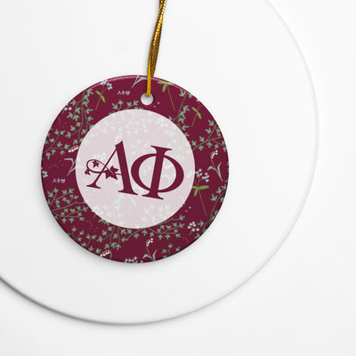 Alpha Phi Holiday ornament with A Phi logo and ivy and lily floral print accents
