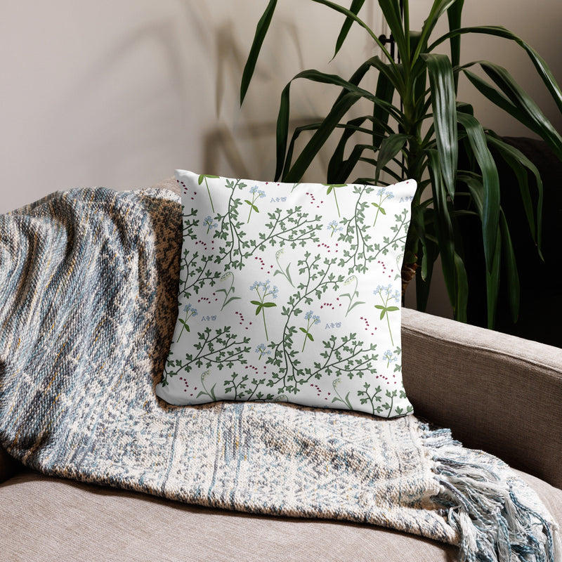 Alpha Phi Silver Letters Sorority Pillow showing floral print on back on couch