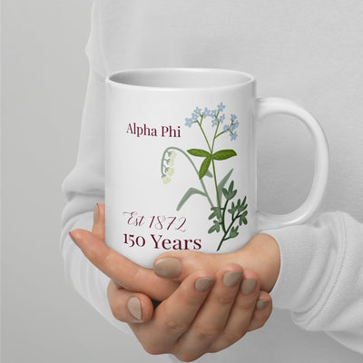 Alpha Phi 150th Anniversary Mug in 20 oz size in model's hands with handle on right