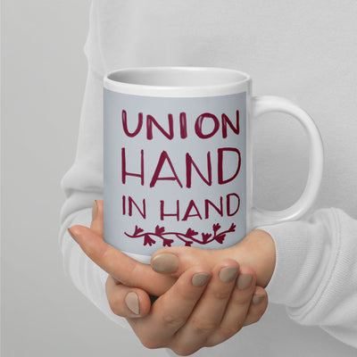 Alpha Phi Sorority Mug with Union Hand in Hand motto in silver and Bordeaux in 20 oz mug size in model's hands