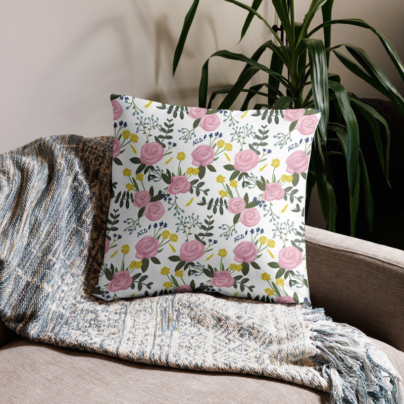 Alpha Xi Delta Realize Motto Pillow in white floral print in 22 x 22 size shown on couch