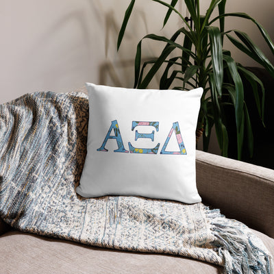 Alpha Xi Delta Sorority Letters Pillow in white in 18 x 18 size shown on couch