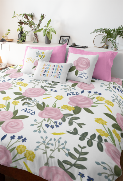 alpha xi delta bedding bundle shown in bedroom setting with 3 pillows