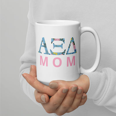 Alpha Xi Delta 15 oz Mom Mug in model's hands showing Alpha Xi letters filled with floral print