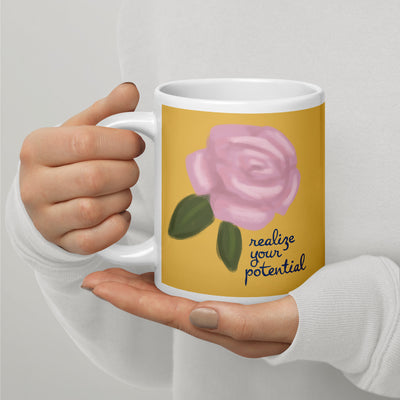 Alpha Xi Delta Sorority Mug in 20 oz size in Quill gold with Realize Your Potential phrase in model's hands