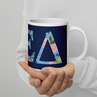 Alpha Xi Delta Sorority Mug in model's hands in 20 oz size showing letters wrapping around mug