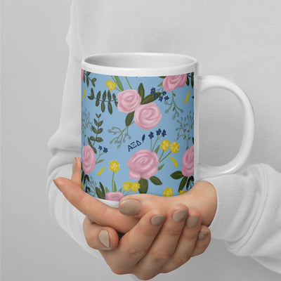 Alpha Xi Delta Sorority Mug in light blue 20 oz size in model's hands with handle on right