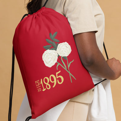 Chi Omega 1895 Drawstring Bag shown on model's shoulder with 1895 design