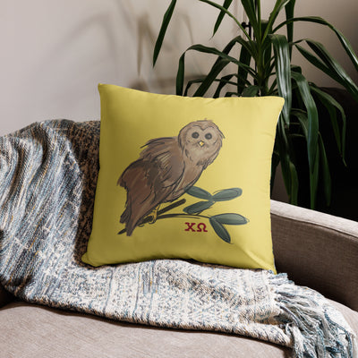 Chi Omega Owl Mascot Pillow in 22" x 22" size shown on chair