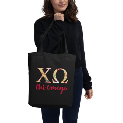 Chi Omega Sorority Tote Bag in black with scarlet red lettering in model's hands