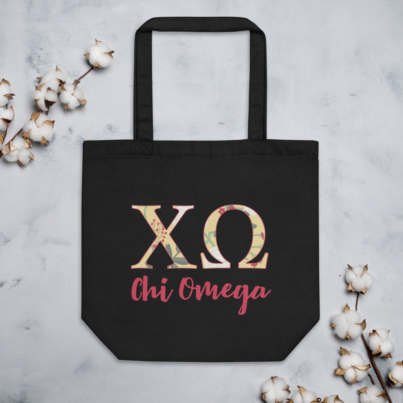 Chi Omega Sorority Tote Bag in black with scarlet red lettering shown with cotton blossoms