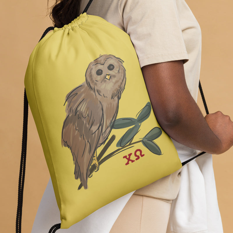 Chi Omega Owl Drawstring Bag shown in straw gold color with artist-drawn Owl mascot design 